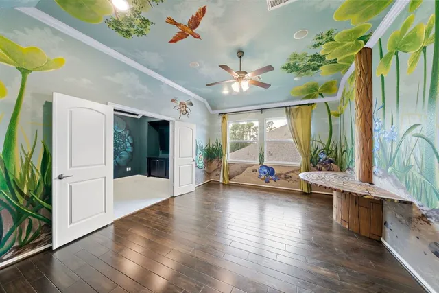 a very nice looking room with wooden floor and a large window