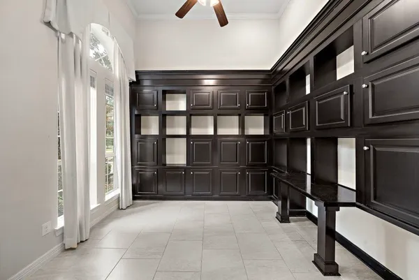 an empty room with fireplace and windows