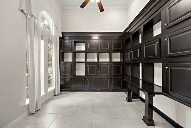 an empty room with fireplace and windows