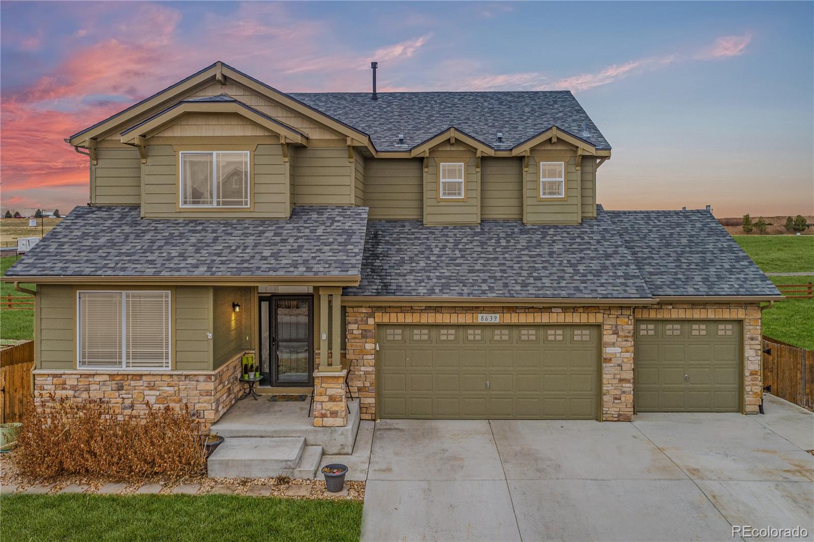 8639 Raspberry Drive Frederick, CO 80504 - Photo 1 of 30 a front view of a house with a yard and garage