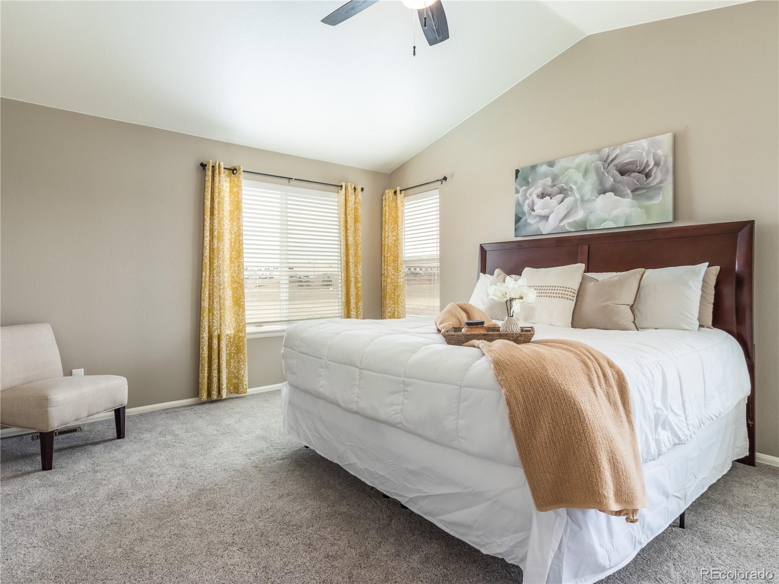 8639 Raspberry Drive Frederick, CO 80504 - Photo 16 of 30 a spacious bedroom with a bed and a couch