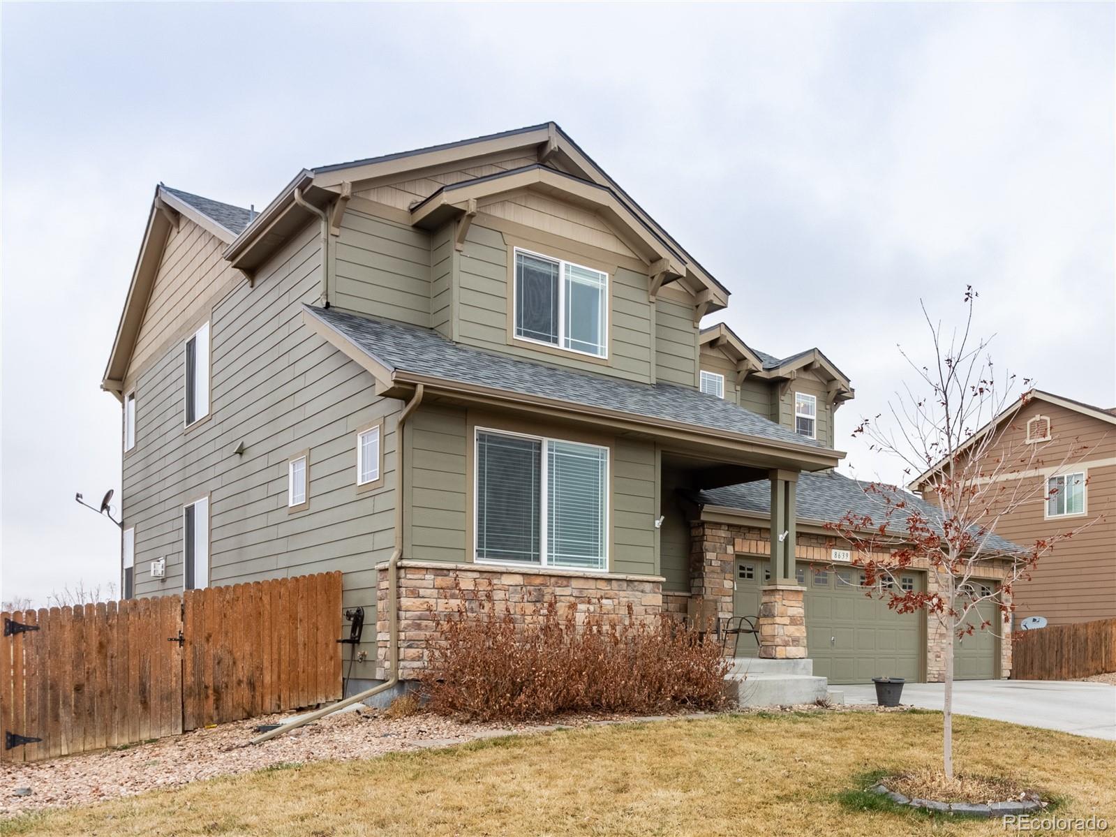 8639 Raspberry Drive Frederick, CO 80504 - Photo 4 of 30 a front view of a house with a yard