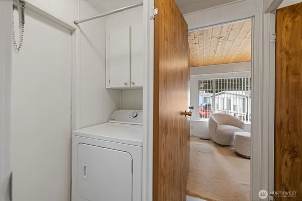 a living room with furniture a flat screen tv and windows
