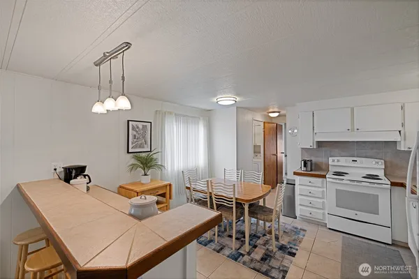 a kitchen with stainless steel appliances a stove a refrigerator and cabinets