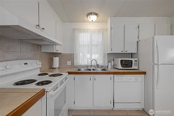 a kitchen with a sink appliances and cabinets