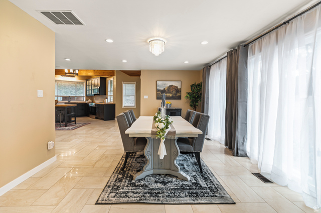 460 Omni Point Road Central Valley, UT 84754 - Photo 32 of 101 Spacious dining area featuring neutral-toned tile flooring, recessed lighting, and a crystal chandelier