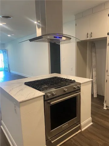 a stove top oven sitting inside of a kitchen