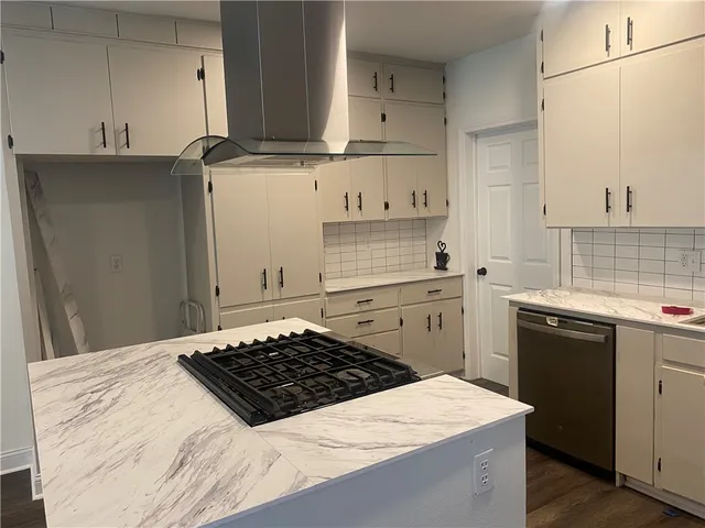 a kitchen with a sink stove and cabinets