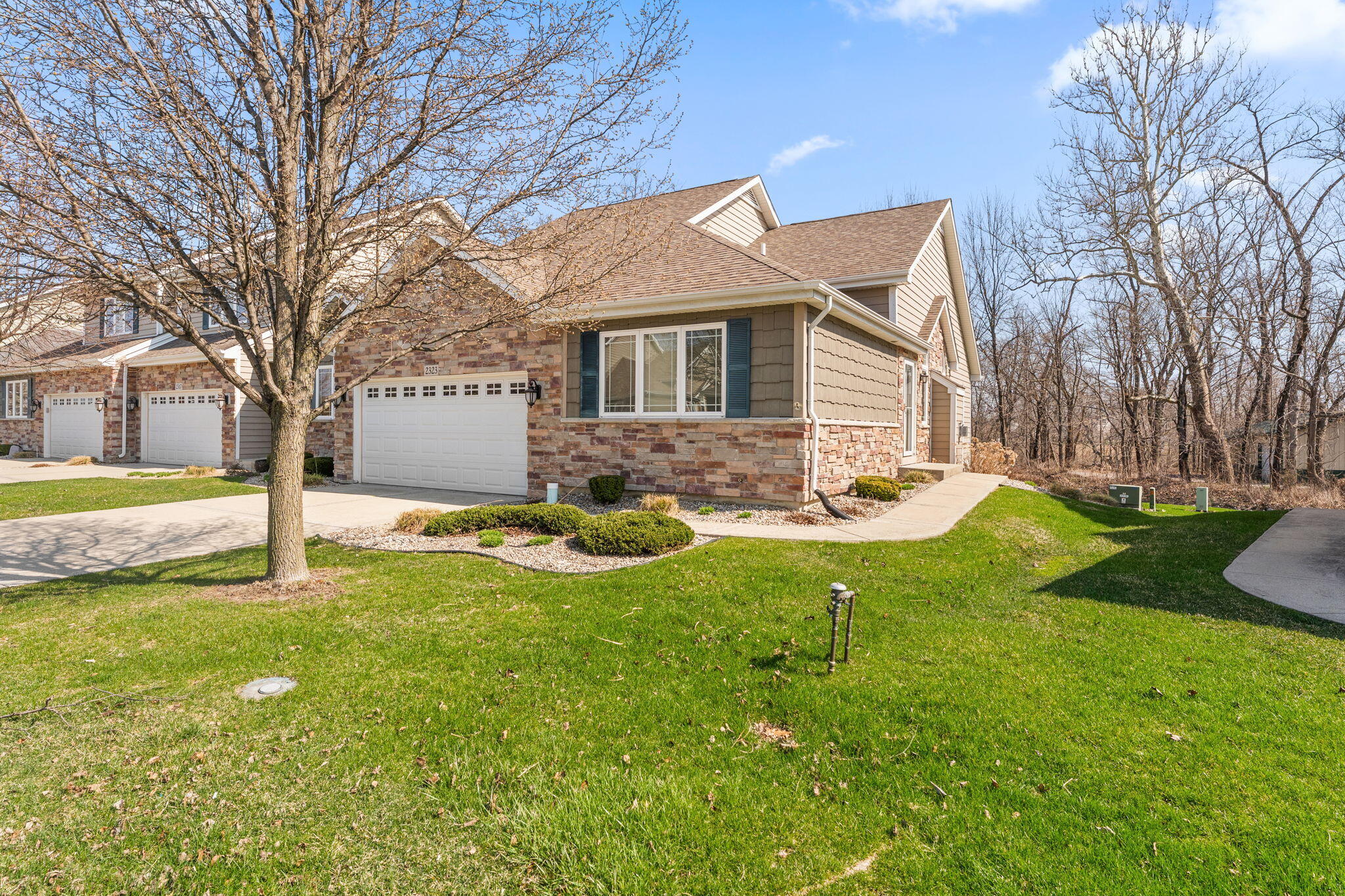 a view of a house with a yard patio and fire pit