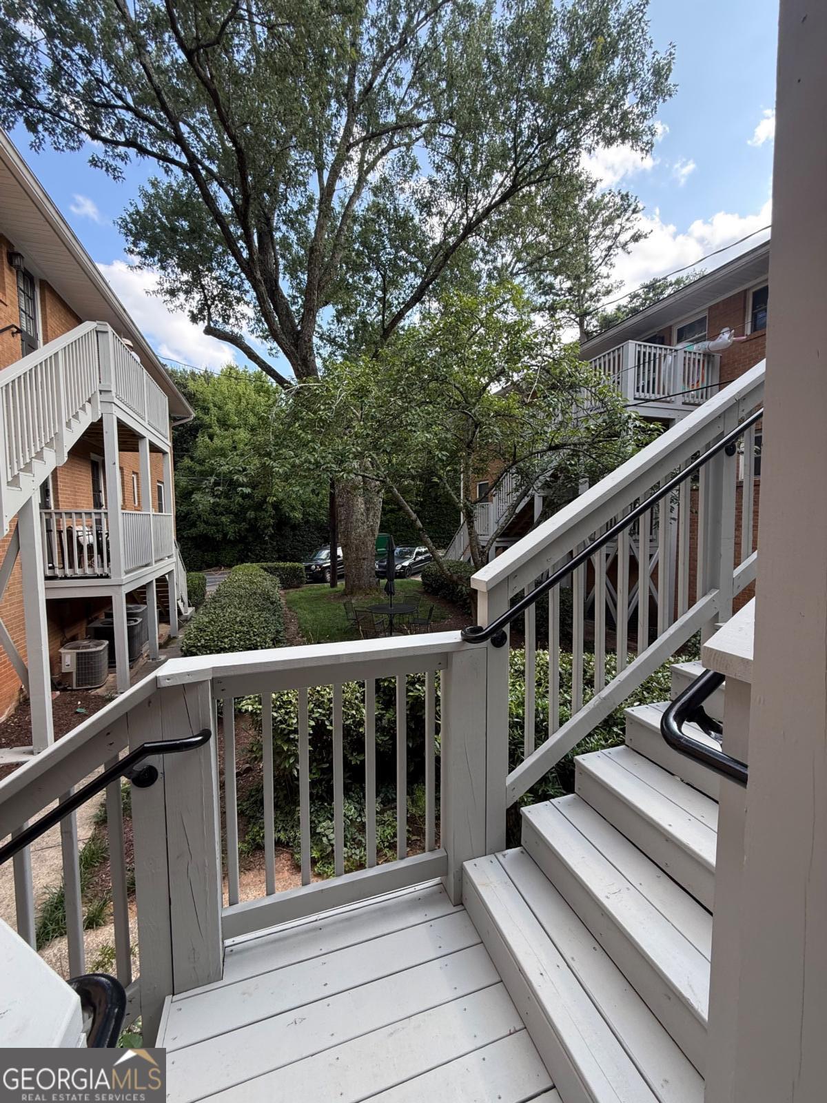 3510 Roswell Road, Unit H1 Atlanta, GA 30326 - Photo 27 of 43 a balcony with wooden floor and outdoor seating