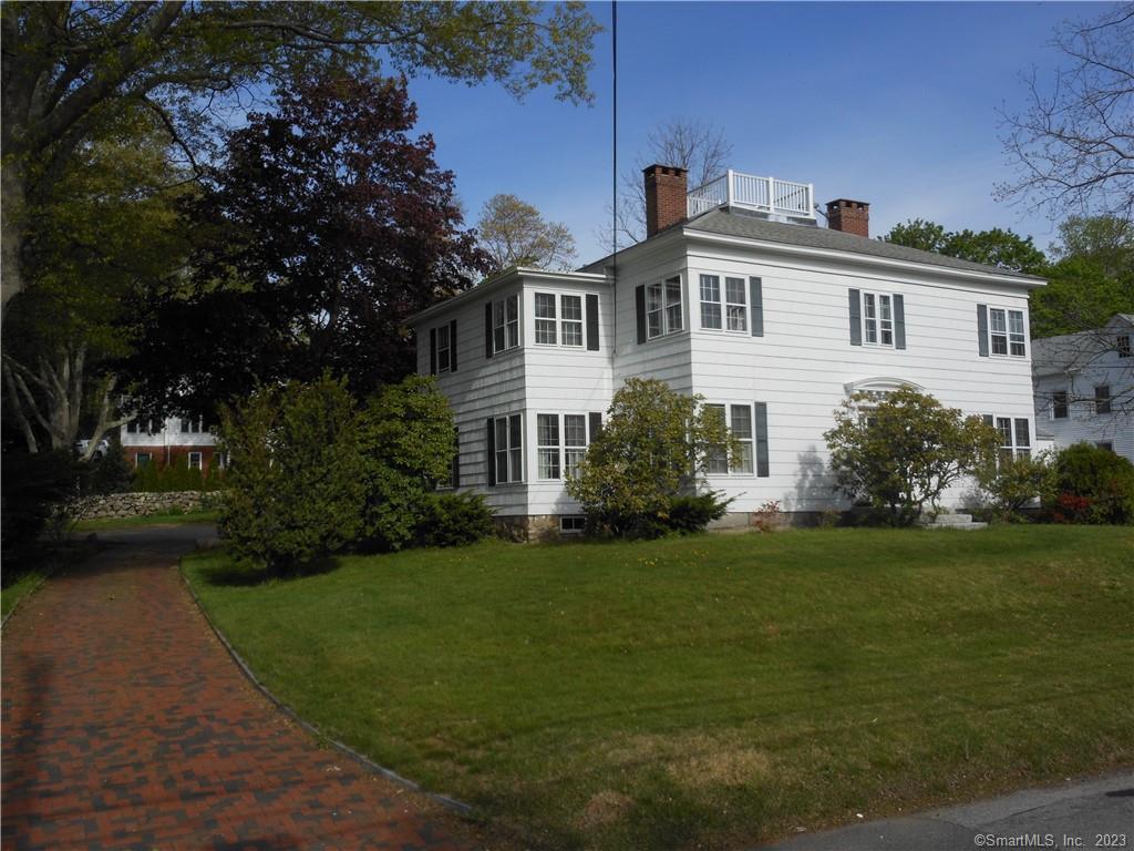 181 High Street, Unit 2 Mystic, CT 06355 - Photo 1 of 1 a front view of a house with a garden