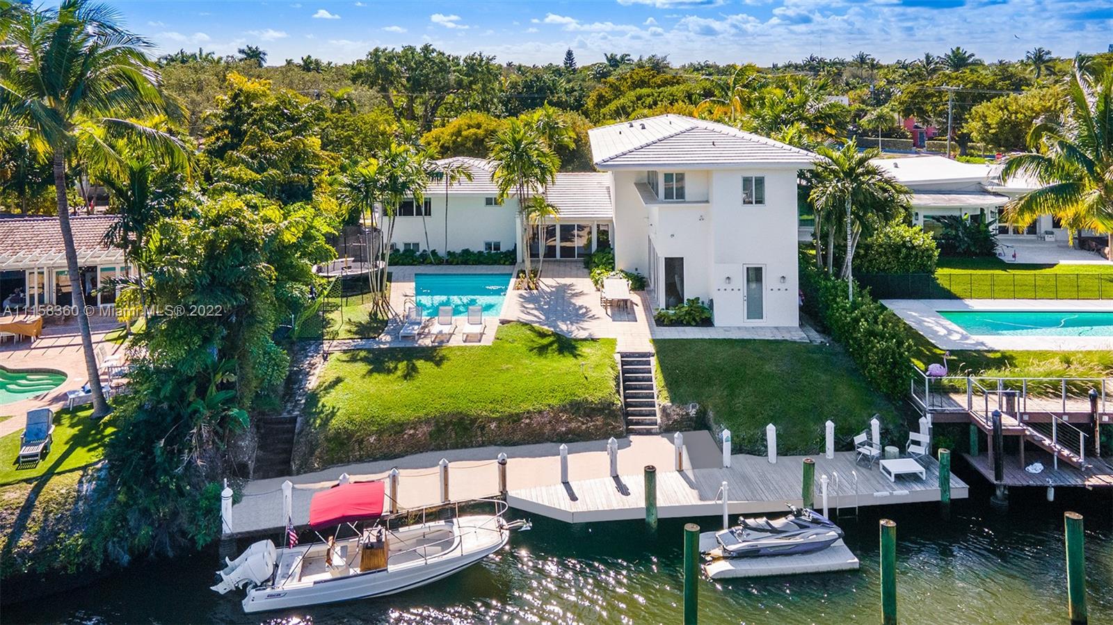 an aerial view of a house with swimming pool garden and patio