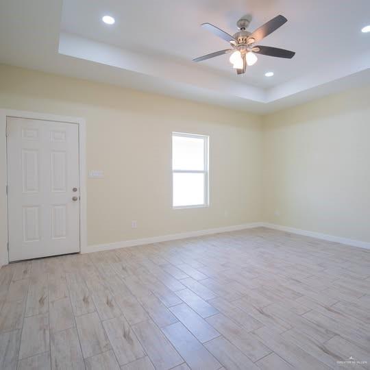 3052 Briggs Road, Unit C Weslaco, TX 78596 - Photo 7 of 16 Spacious interior room featuring wood-finish flooring, a white paneled door, and a single window