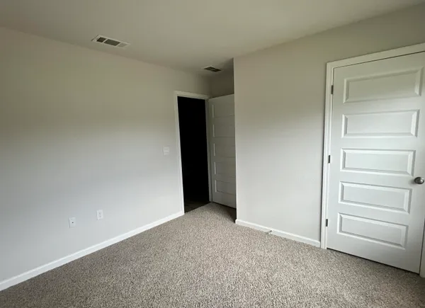 a view of an empty room and closet