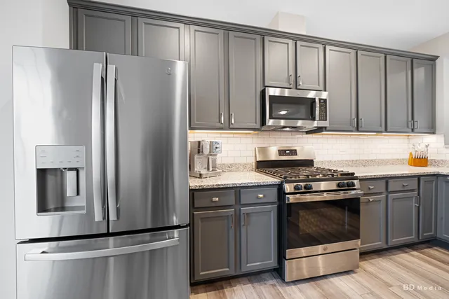 a kitchen with a refrigerator stove and microwave