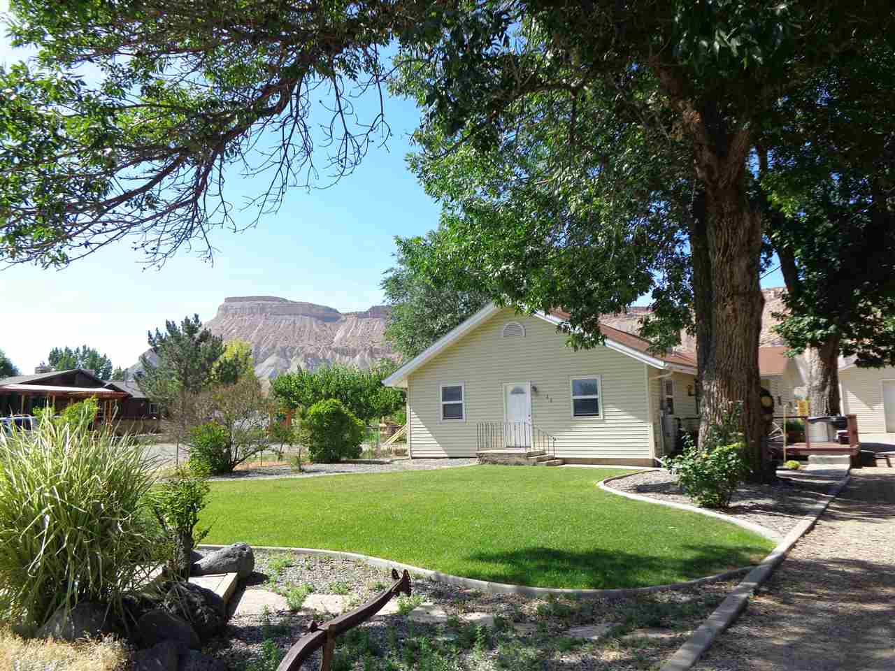 3628 G Road Palisade, CO 81526 - Photo 1 of 24 a view of a backyard with plants and a garden