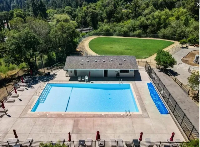 an aerial view of a house with a swimming pool
