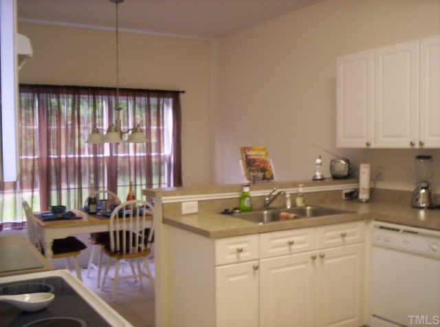 4213 Beacon Crest Way Raleigh, NC 27604 - Photo 3 of 6 a kitchen with a sink cabinets and window