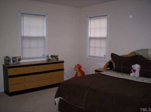 4213 Beacon Crest Way Raleigh, NC 27604 - Photo 6 of 6 a bedroom with two beds and a window