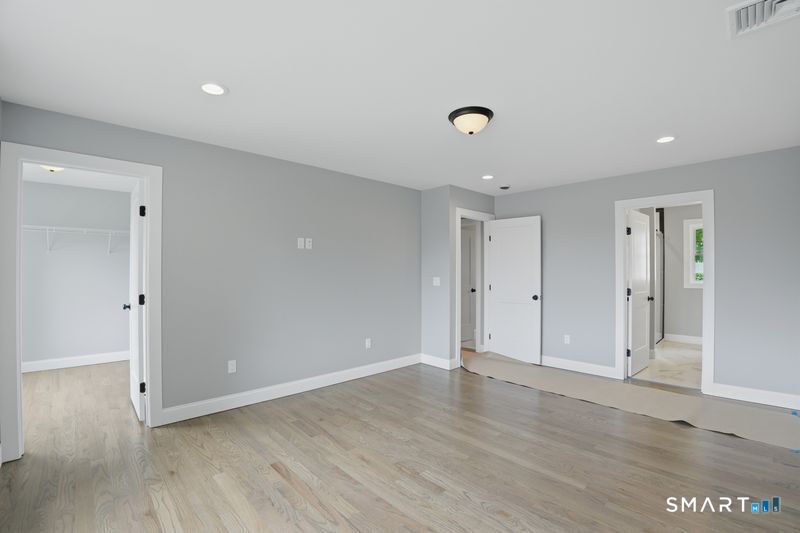 796 Maple Hill Road Naugatuck, CT 06770 - Photo 22 of 35 an empty room with wooden floor and windows