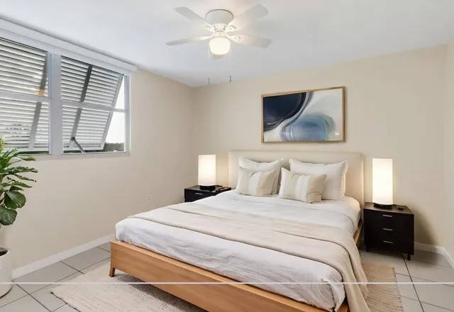 a room with stainless steel appliances a refrigerator and a potted plant