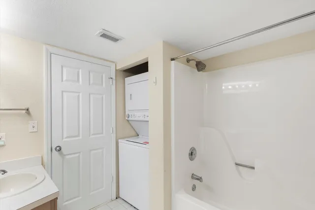 a view of an empty room and window ceiling fan