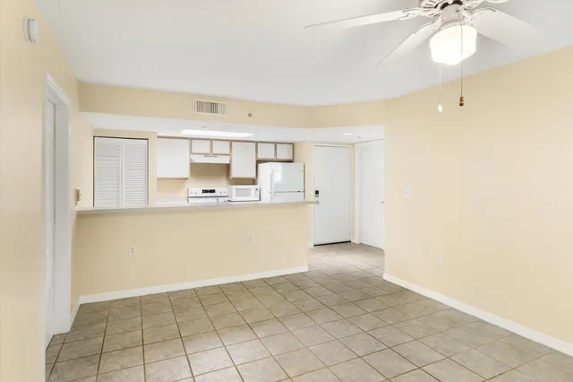 a front view of multi story residential apartment building with yard and green space