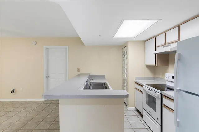 a living room with furniture a flat screen tv and a large window