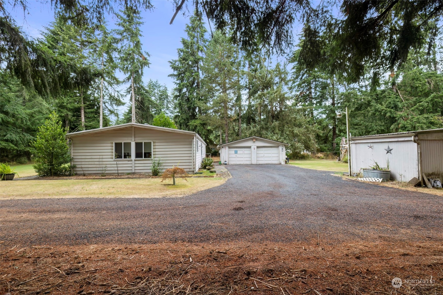 7344 191st Avenue Southwest Rochester, WA 98579 - Photo 27 of 39 a front view of a house with a yard and a garage