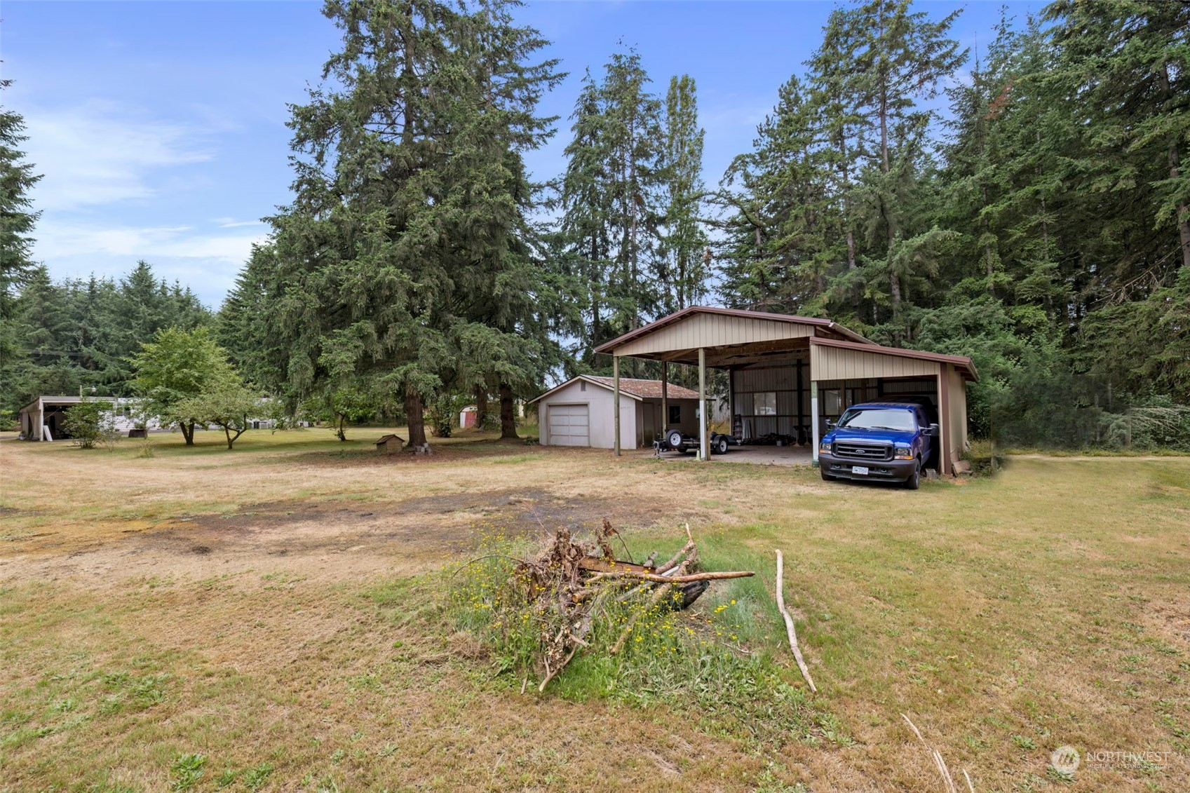7344 191st Avenue Southwest Rochester, WA 98579 - Photo 34 of 39 a front view of a house with a yard and trees