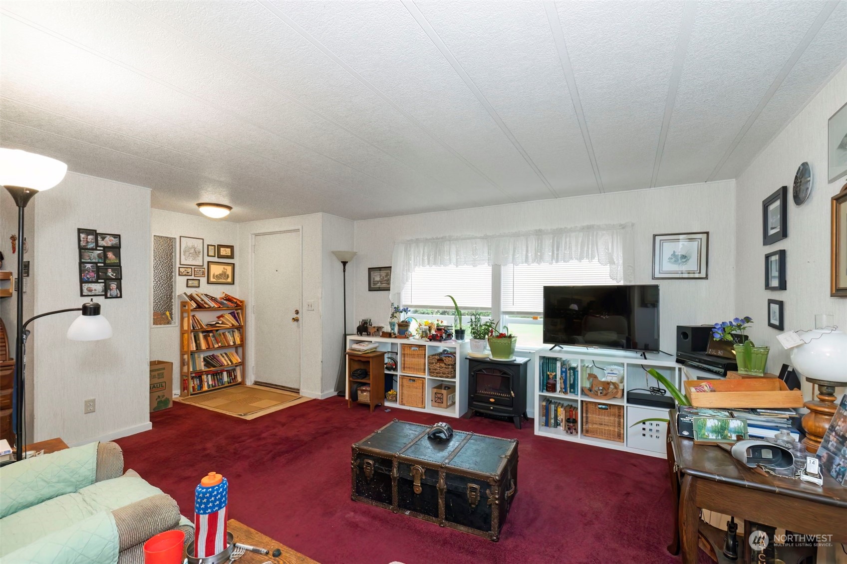 7344 191st Avenue Southwest Rochester, WA 98579 - Photo 6 of 39 a living room with furniture a flat screen tv and gym equipment