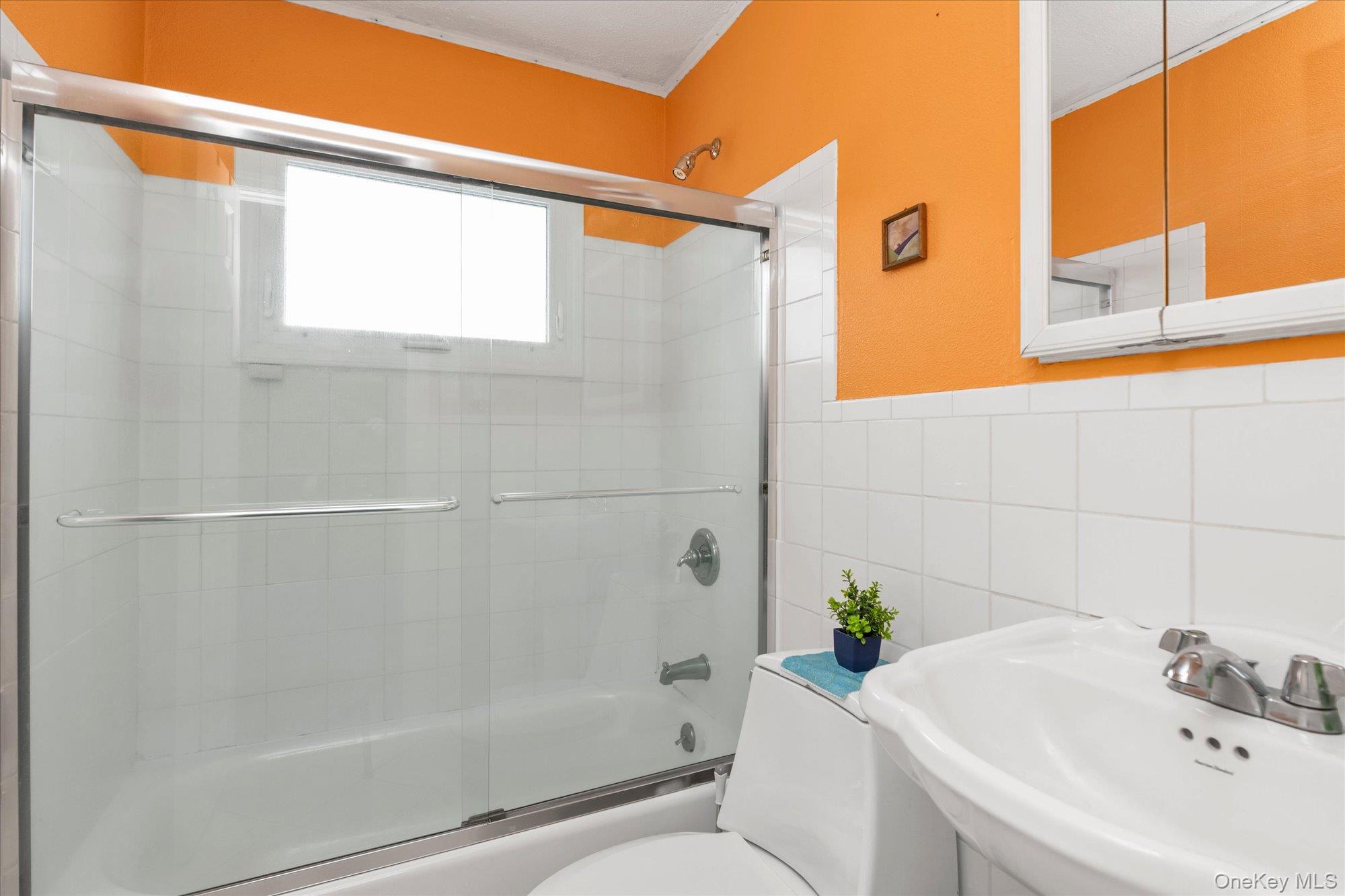 31 Steven Street Plainview, NY 11803 - Photo 11 of 21 a white bath tub sitting next to a white sink and a shower