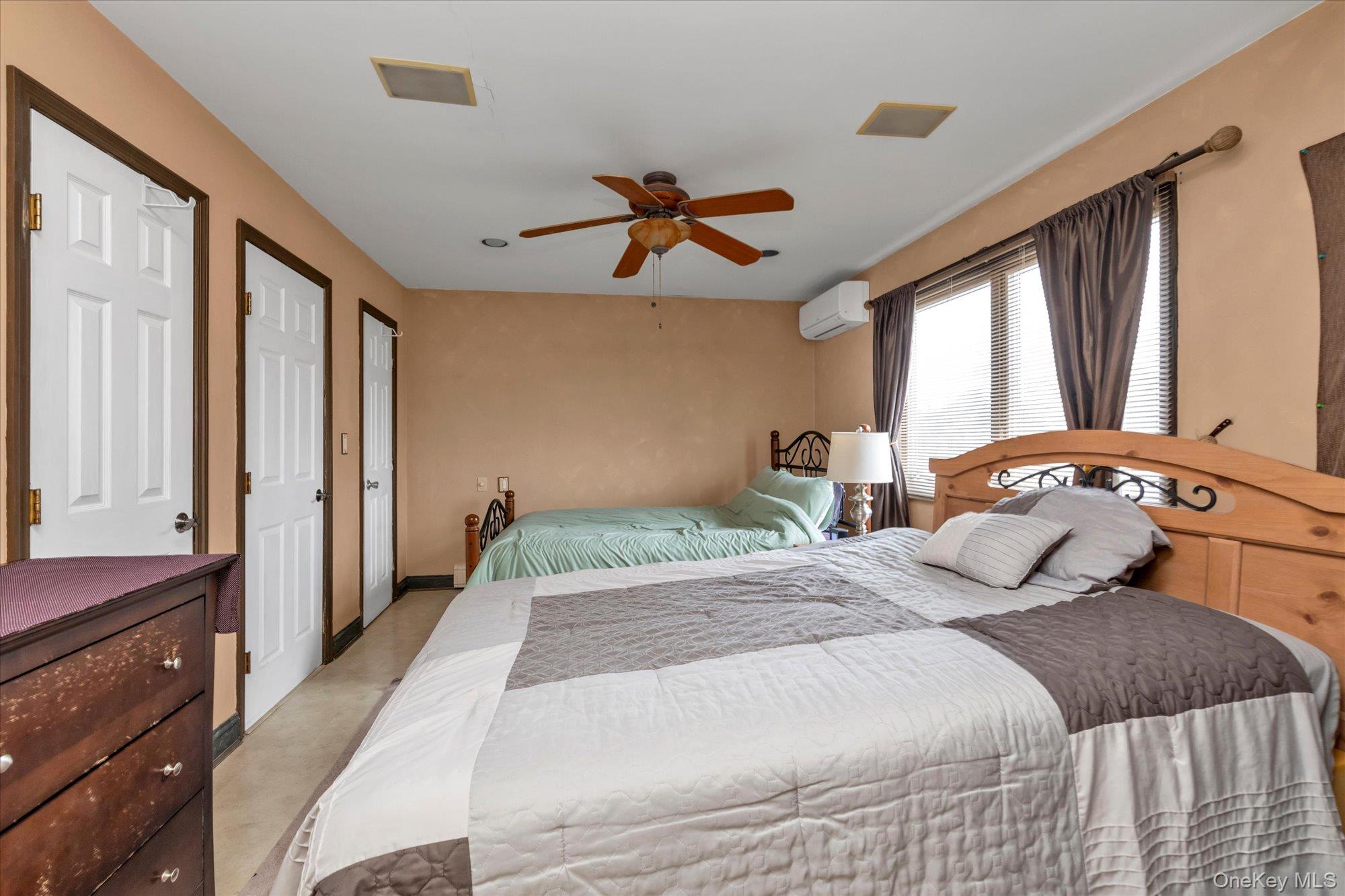 31 Steven Street Plainview, NY 11803 - Photo 16 of 21 a bedroom with a bed and a chandelier