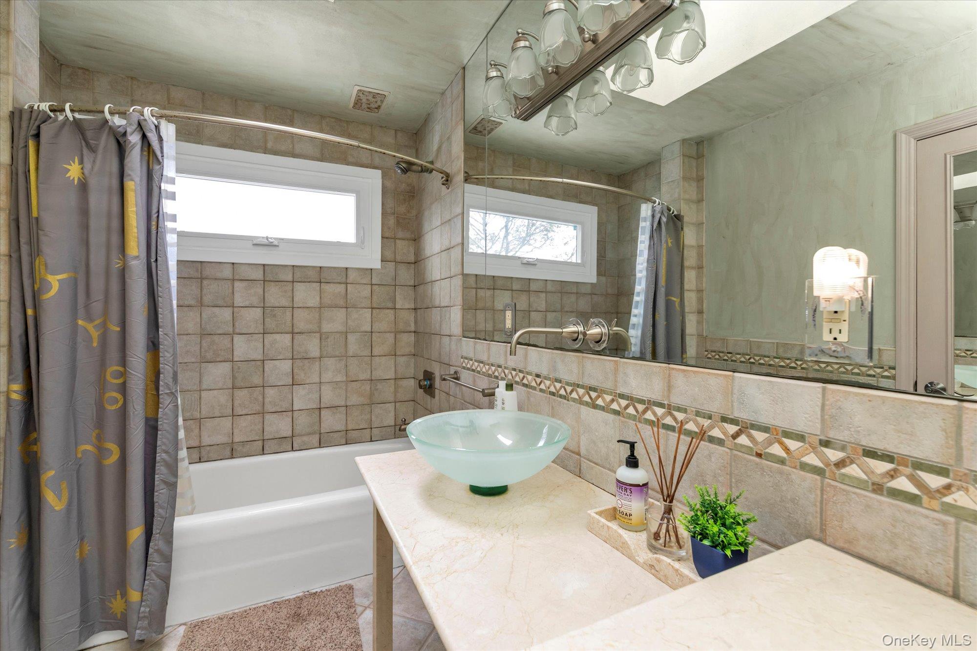 31 Steven Street Plainview, NY 11803 - Photo 17 of 21 a bathroom with a sink mirror and a bathtub