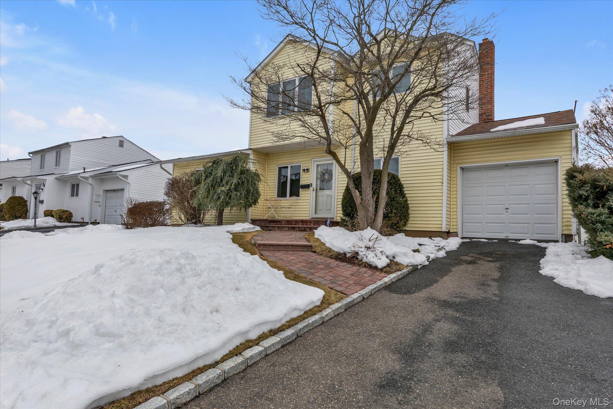 31 Steven Street Plainview, NY 11803 - Photo 20 of 21 a view of a white house with a snow on the road
