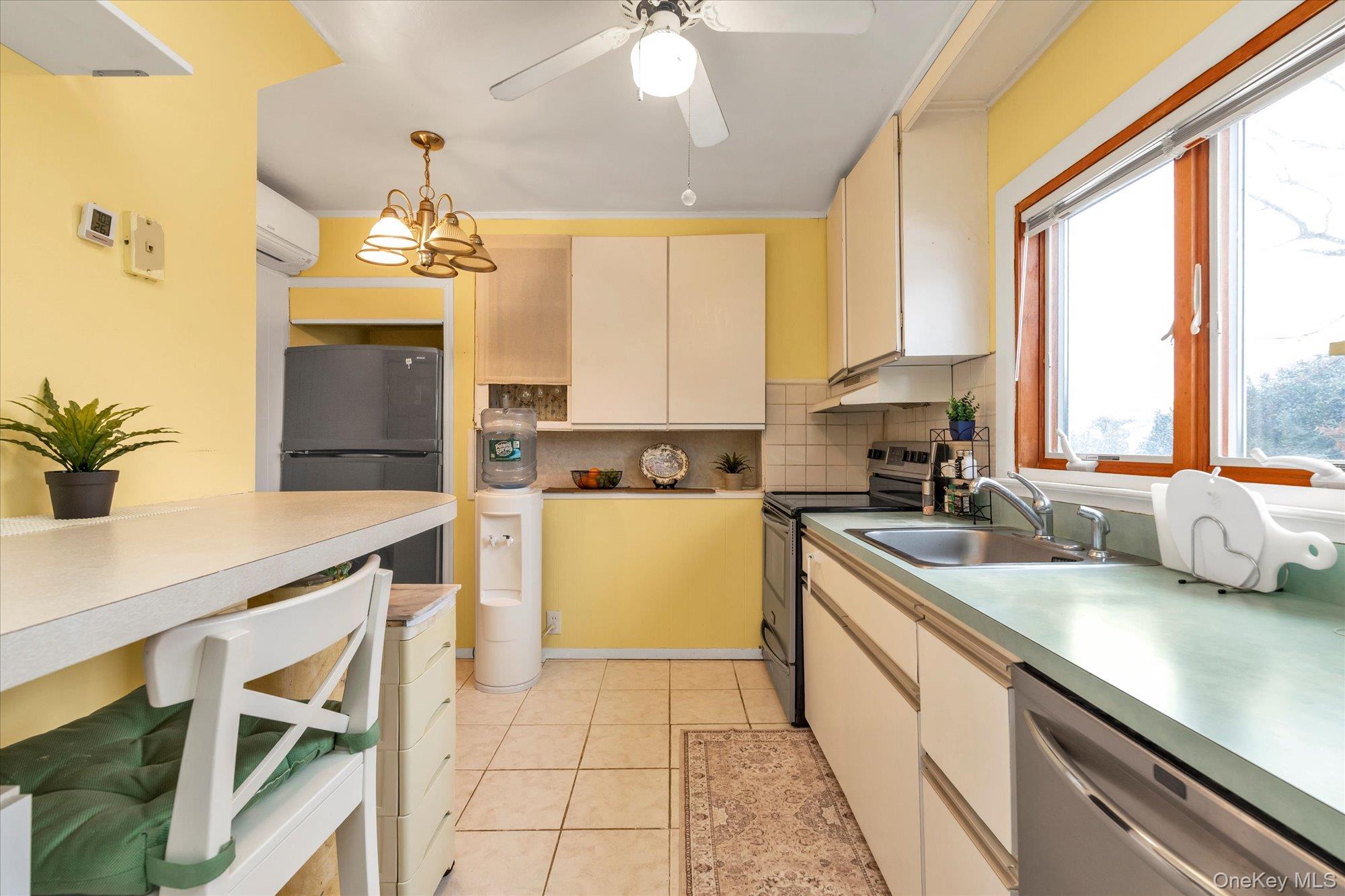 31 Steven Street Plainview, NY 11803 - Photo 4 of 21 a kitchen with a sink a counter top space appliances and cabinets