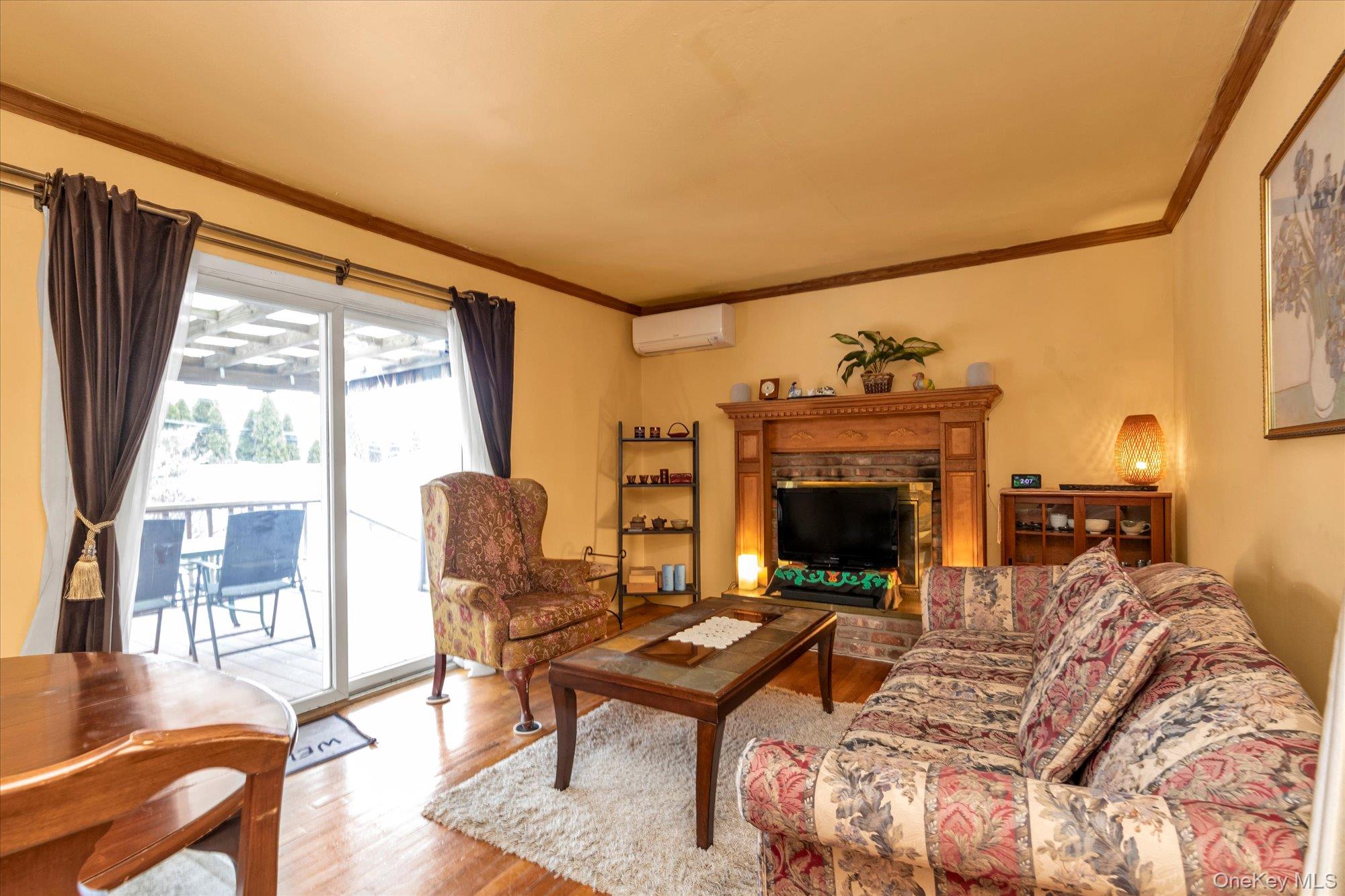 31 Steven Street Plainview, NY 11803 - Photo 7 of 21 a living room with furniture large window and a fireplace