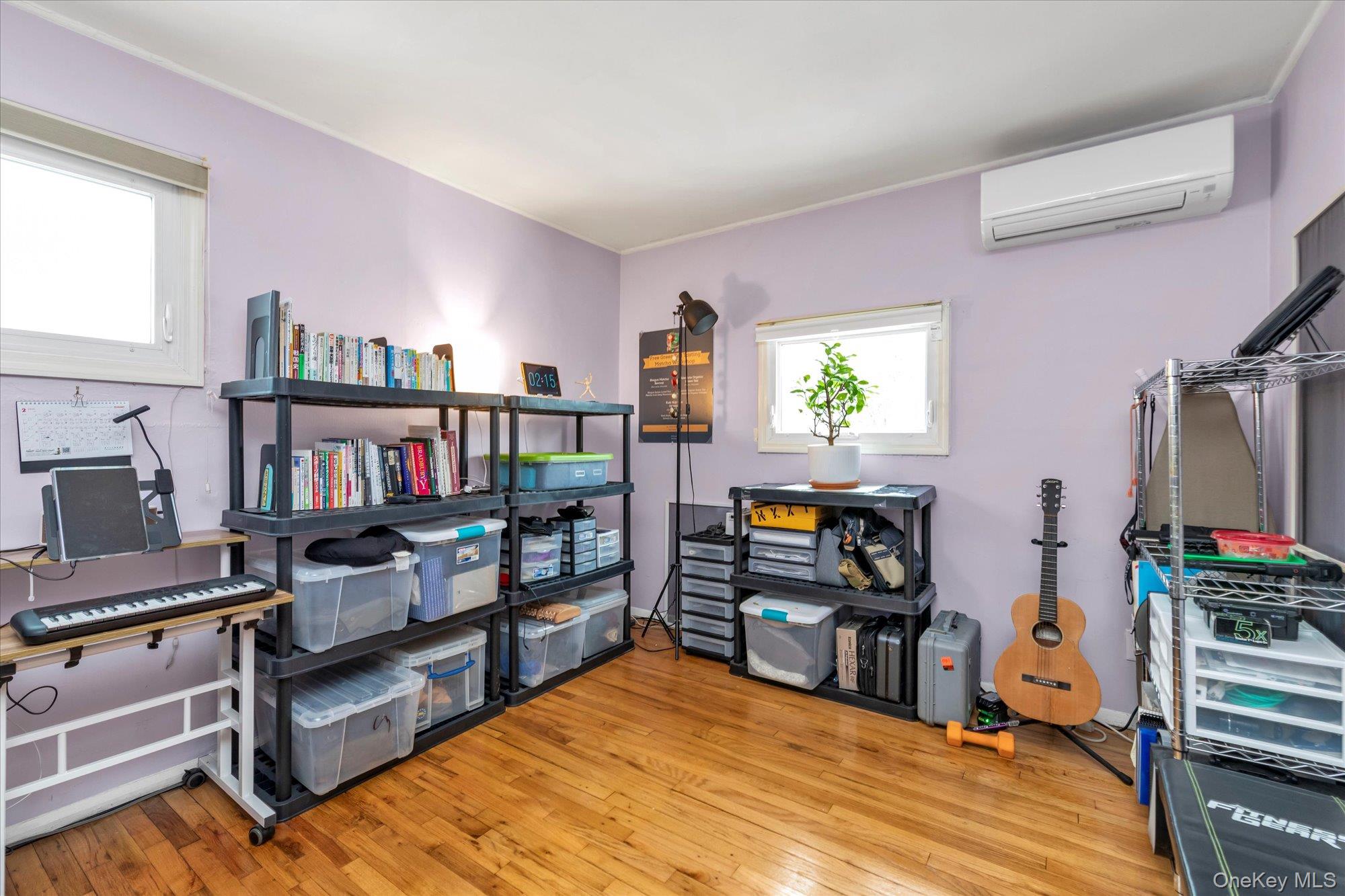 31 Steven Street Plainview, NY 11803 - Photo 9 of 21 a bedroom with furniture and a book shelf