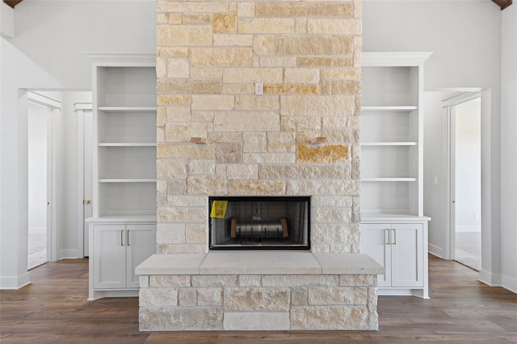 348 Lacek Mill Road China Spring, TX 76633 - Photo 5 of 40 a living room with a fireplace and a walk in closet with wooden floor