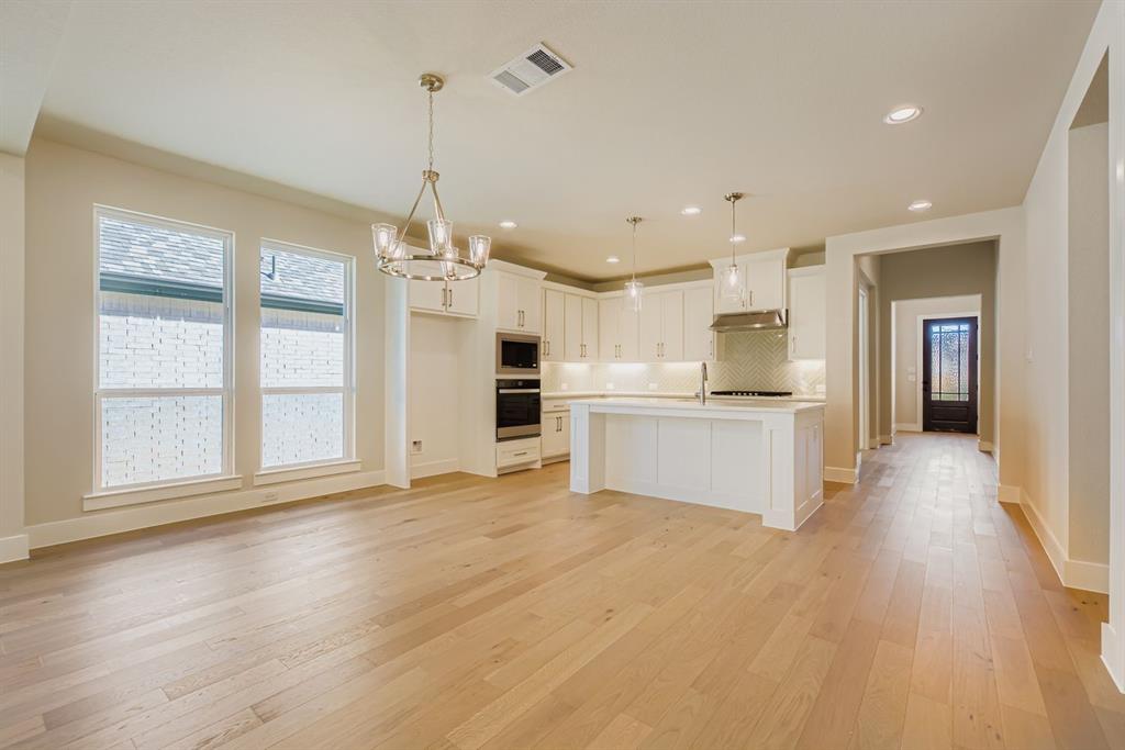 4123 Windy Point Court Oak Point, TX 75068 - Photo 12 of 29 a view of a kitchen with a stove cabinets and a kitchen