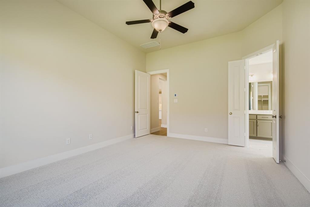 4123 Windy Point Court Oak Point, TX 75068 - Photo 15 of 29 a view of an empty room and a ceiling fan