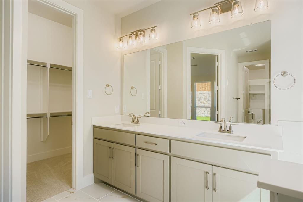 4123 Windy Point Court Oak Point, TX 75068 - Photo 16 of 29 a bathroom with double sink and a mirror