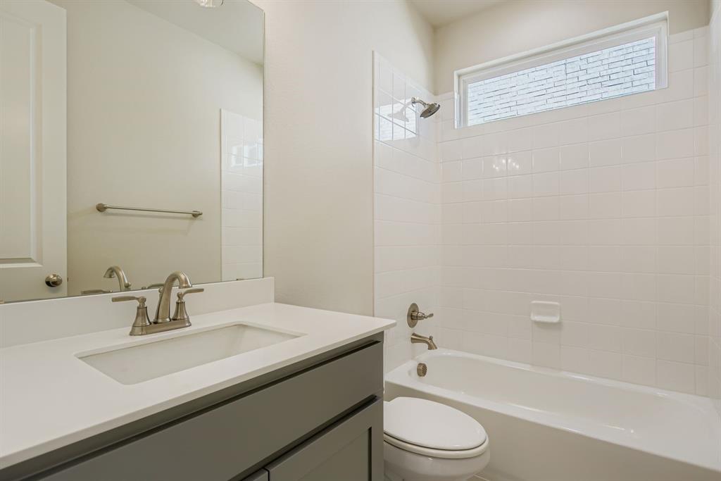 4123 Windy Point Court Oak Point, TX 75068 - Photo 20 of 29 a bathroom with a sink a toilet and shower