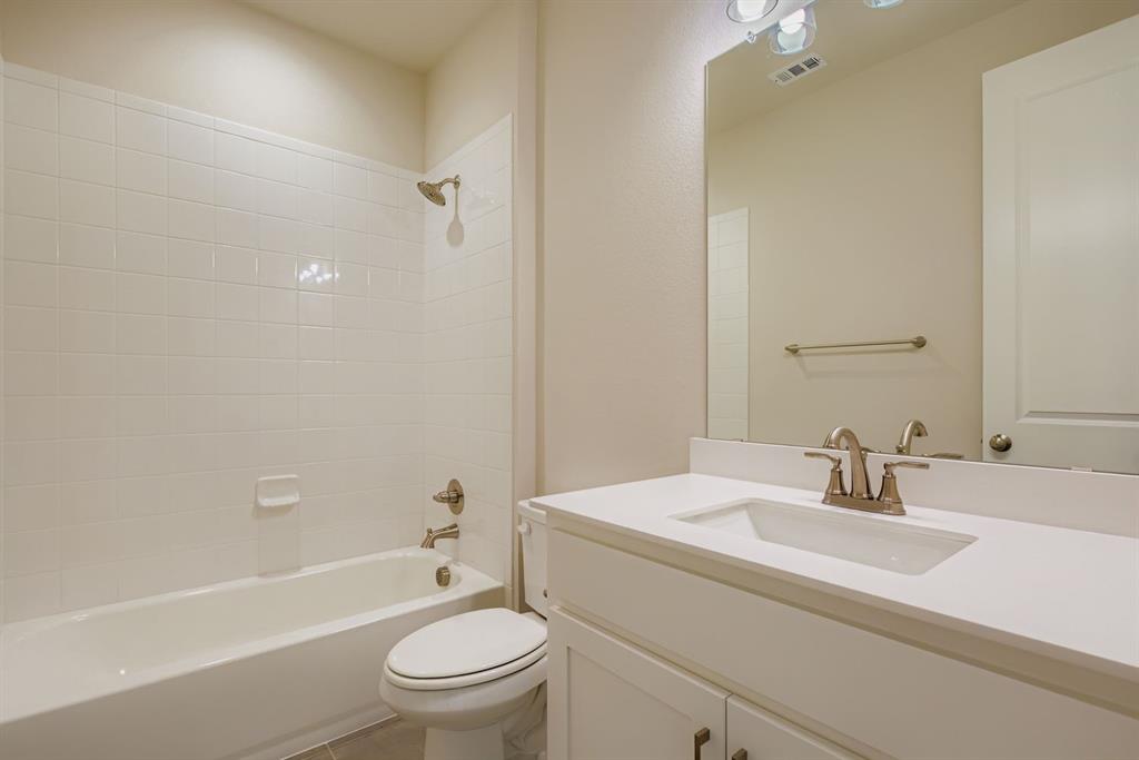 4123 Windy Point Court Oak Point, TX 75068 - Photo 25 of 29 a bathroom with a sink toilet and shower