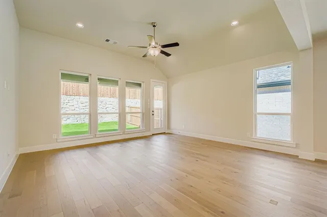 a view of an empty room with a ceiling fan
