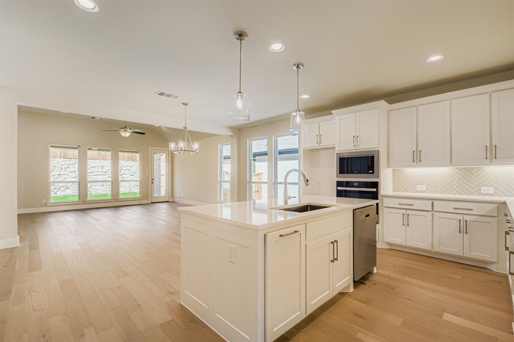 4123 Windy Point Court Oak Point, TX 75068 - Photo 10 of 29 a kitchen with appliances a sink and cabinets