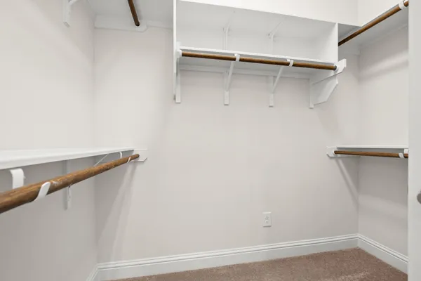 a white bath tub sitting next to a shower