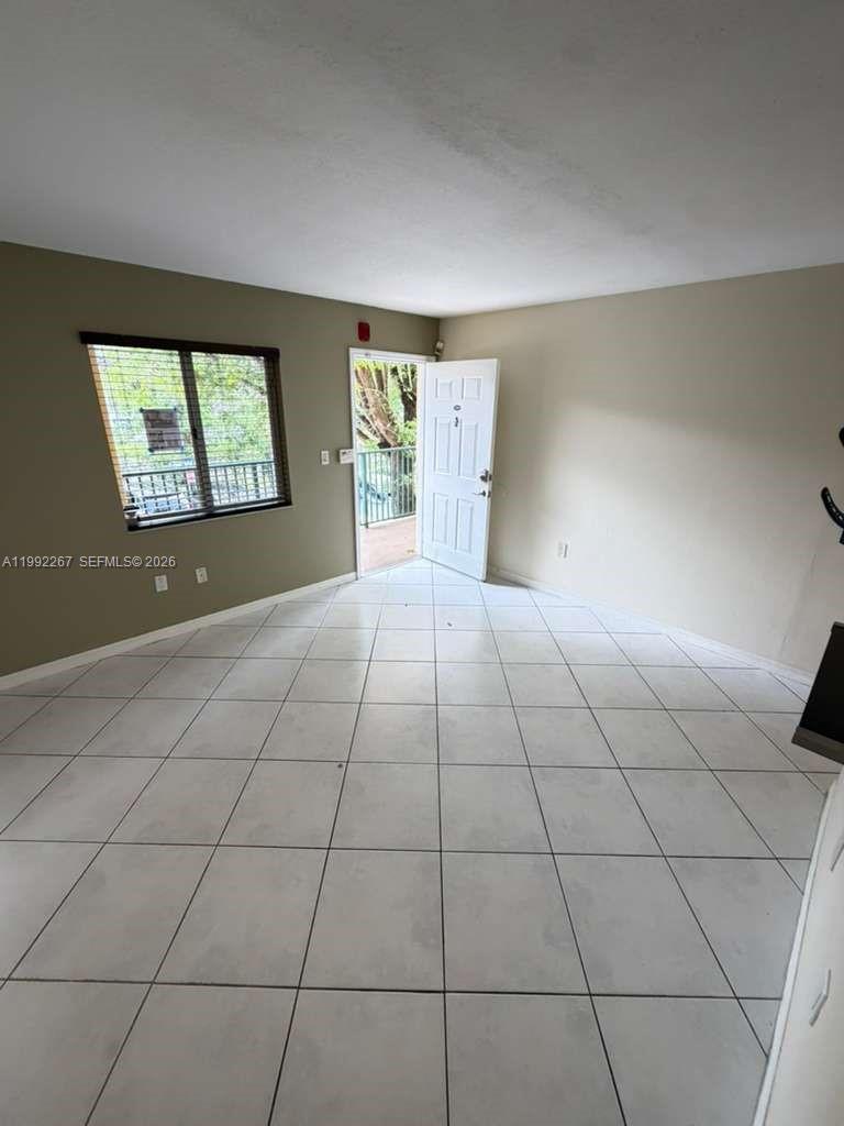 12625 Southwest 91st Street, Unit 209 Miami, FL 33186 - Photo 1 of 17 a view of an empty room with a window