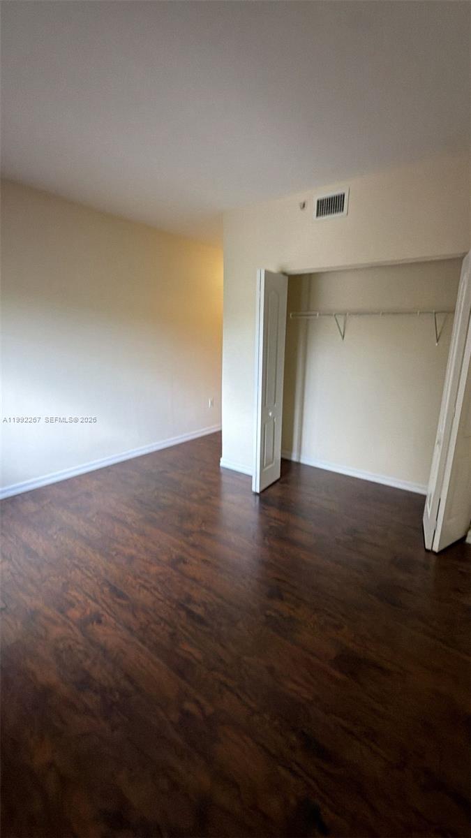 12625 Southwest 91st Street, Unit 209 Miami, FL 33186 - Photo 12 of 17 wooden floor in an empty room