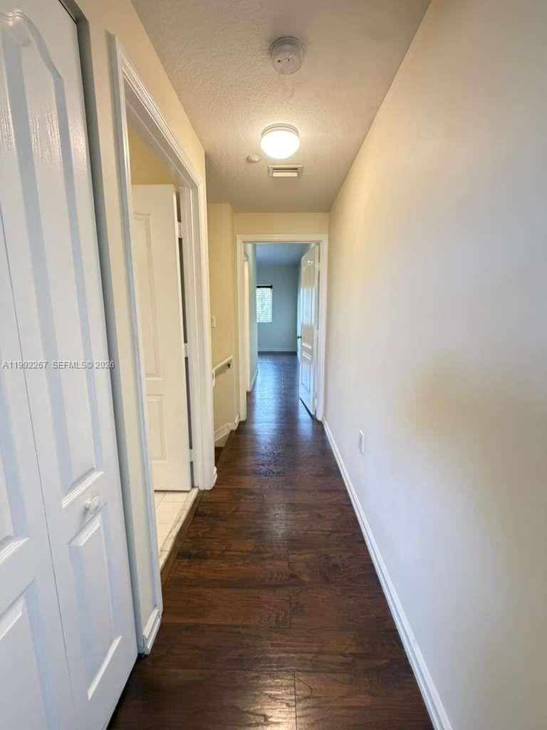 12625 Southwest 91st Street, Unit 209 Miami, FL 33186 - Photo 15 of 17 a view of a hallway with wooden floor